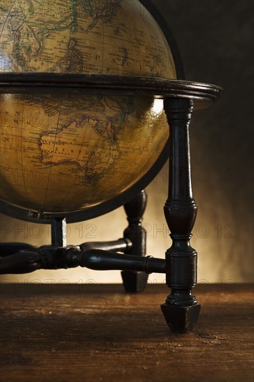Close up of antique globe on table.