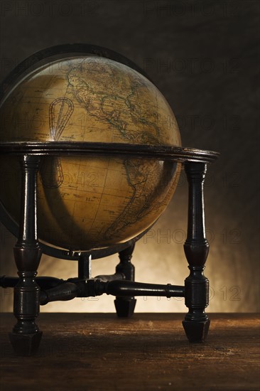 Close up of antique globe on table.