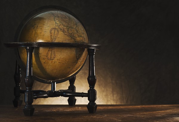 Close up of antique globe on table.