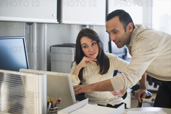 Business man and woman working in office.