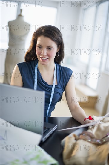 Young fashion designer using laptop.