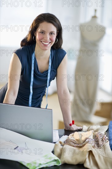 Portrait of young fashion designer at work.