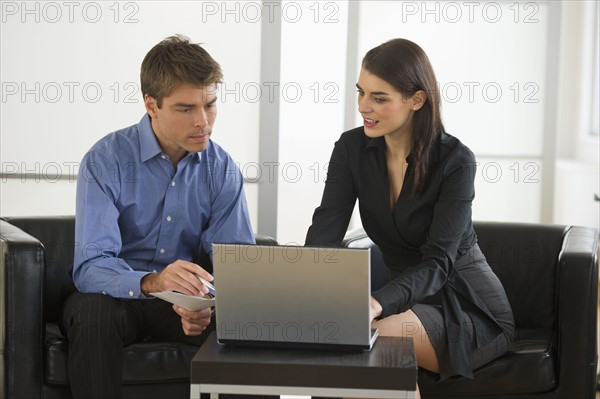 Pair of businesspeople working in office.