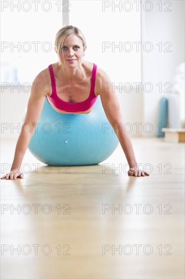 Woman exercising on fitness ball. Photo : Daniel Grill