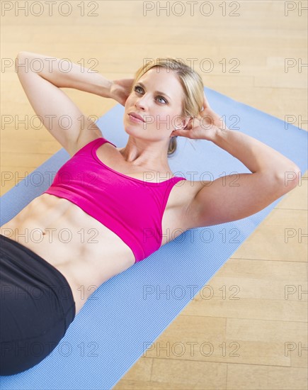 Woman exercising on mat. Photo : Daniel Grill