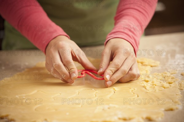 Close-up of girl (6-7) making cookies. Photo : Mike Kemp