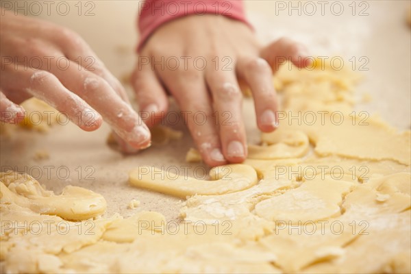 Young womans hands kneading cookie dough. Photo : Mike Kemp