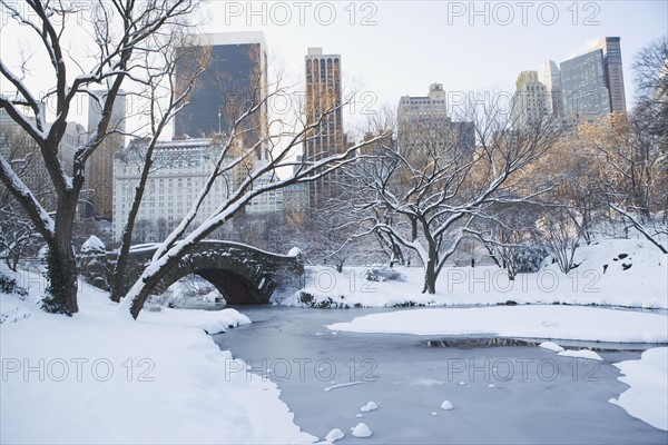 USA, New York City, View of Central Park in winter with Manhattan skyline in background. Photo : fotog