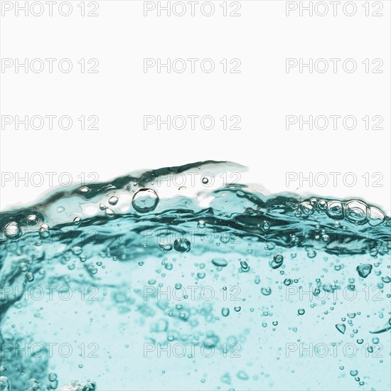 Water with bubbles on white background. Photo : Joe Clark