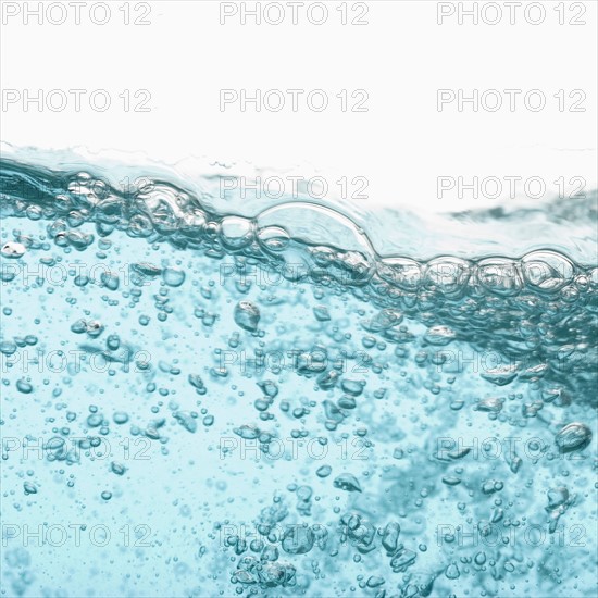 Water with bubbles on white background. Photo : Joe Clark