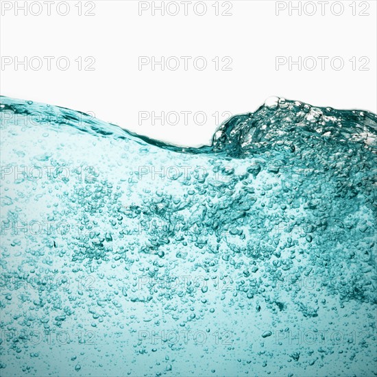 Water with bubbles on white background. Photo : Joe Clark