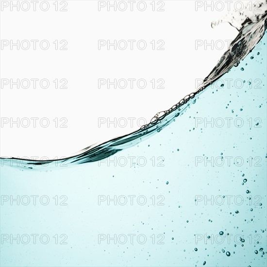 Water with bubbles on white background. Photo : Joe Clark