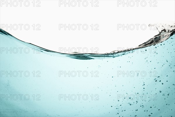 Water with bubbles on white background. Photo : Joe Clark