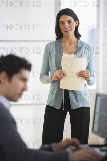 Business man and woman in office.