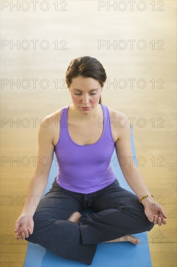 Young woman meditation in lotus position.