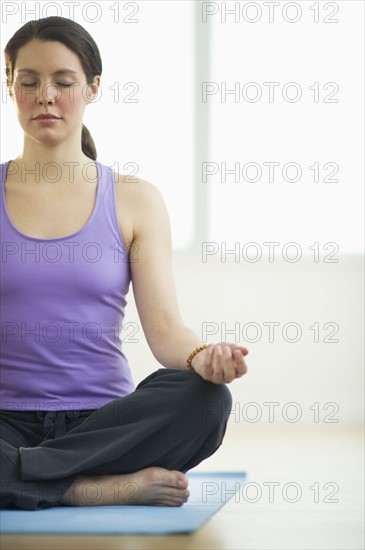 Young woman meditation in lotus position.