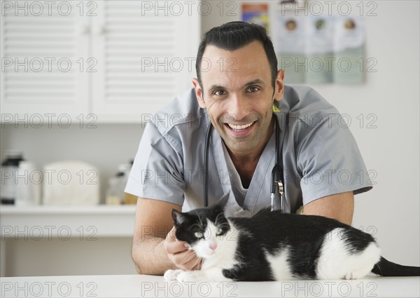 Vet stroking cat in pet clinic.