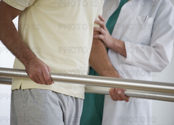 Close-up of physiotherapist assisting patient with recovery exercise.