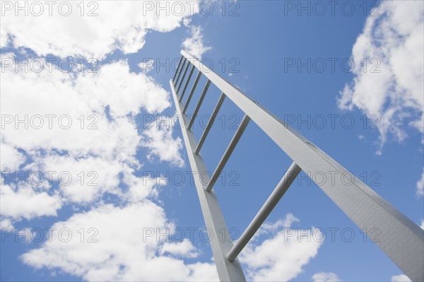 Ladder reaching cloudy sky. Photo : Chris Hackett