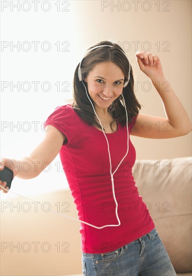 Young woman listening music and dancing. Photo : Mike Kemp