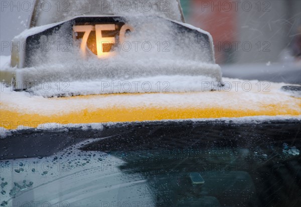 USA, New York City, Taxi roof covered with snow.