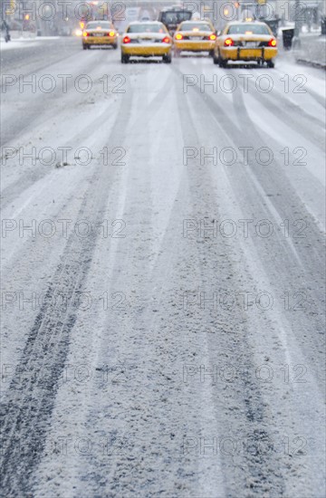 USA, New York City, Yellow taxis in blizzard.