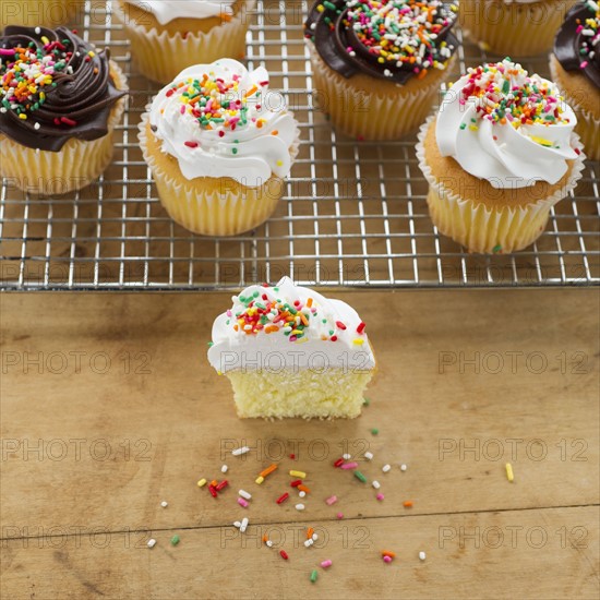 Homemade cupcakes, one with missing bite.