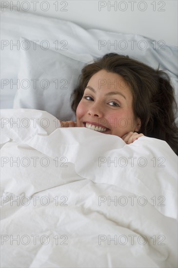 Woman lying in bed.