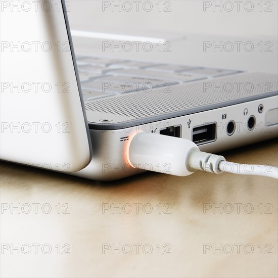 Studio shot of laptop with cable. Photo : Joe Clark