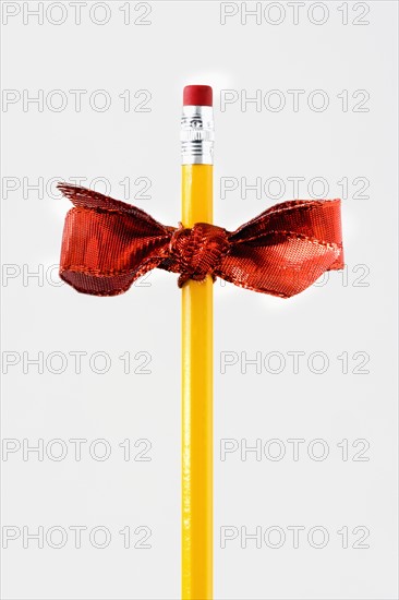 Studio shot of pencil with ribbon. Photo : Joe Clark