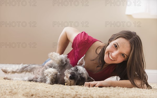 Young woman playing with schnauzer. Photo : Mike Kemp