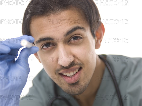 Young surgeon holding small torch. Photo : Dan Bannister