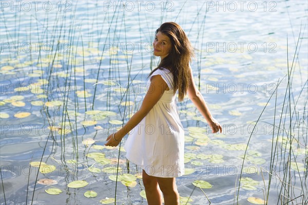 USA, Montana, Portrait of teenage girl (16-17) at lakeside. Photo : Noah Clayton