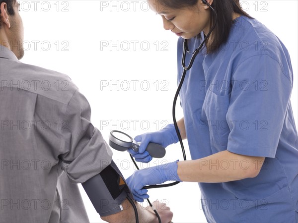 Nurse checking patients blood pressure. Photo : Dan Bannister