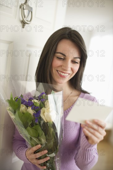 Young happy woman receiving flowers.