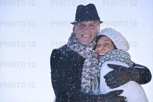 Happy mature couple in winter scenery.