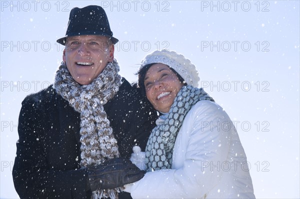 Happy mature couple in winter scenery.