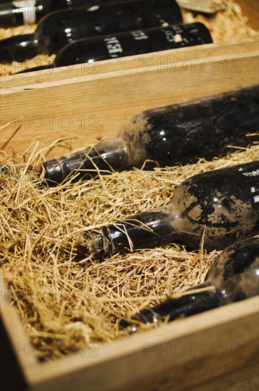 Old wine bottles in wooden box.