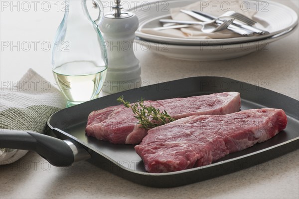 Close up of raw steak on frying pan.