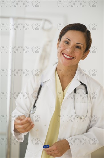 Smiling female doctor with IV drip.