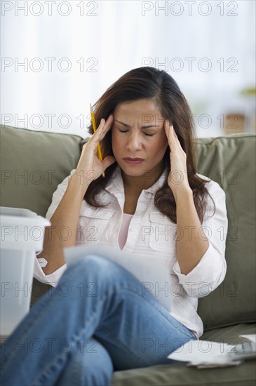 Woman touching head with headache.