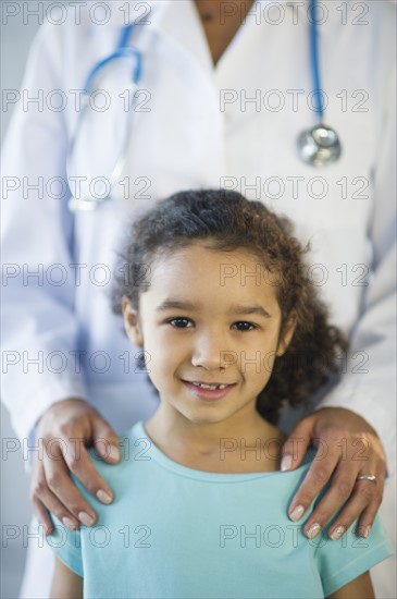 Portrait of smiling girl (6-7) in doctor's office.