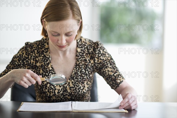 Woman examining documents.