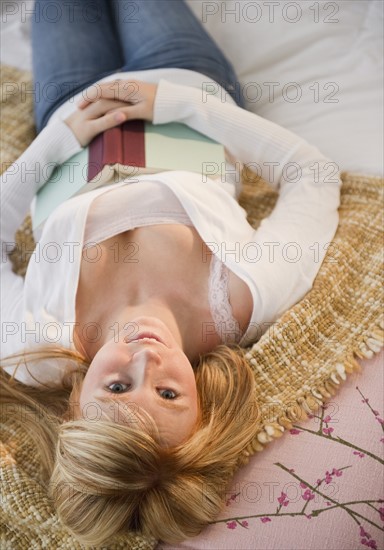 Woman relaxing in bed. Photo: Jamie Grill Photography