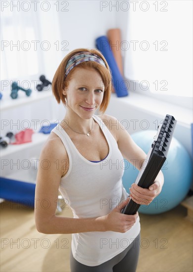 Exercise trainer holding clipboard. Photo : Jamie Grill Photography