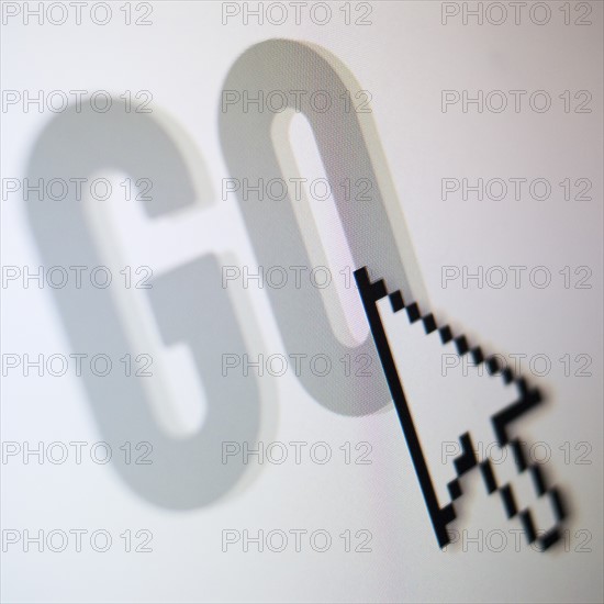 Studio shot of arrow cursor on go button. Photo : Jamie Grill Photography