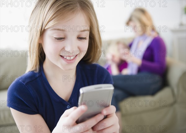 Girl (10-11) holding remote control. Photo : Jamie Grill Photography