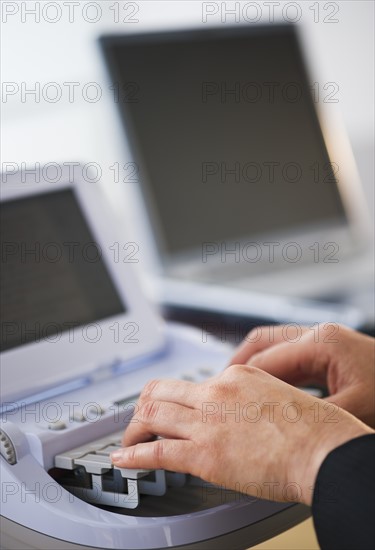 Court stenographer using stenograph machine. Photo: Daniel Grill