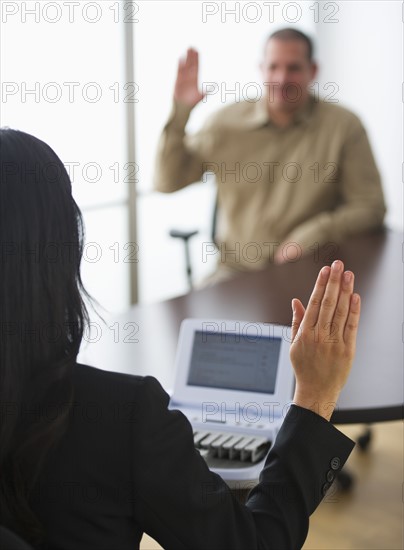 Court stenographer and client raising hands. Photo: Daniel Grill