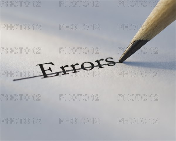 Studio shot of pencil crossing out the word errors from piece of paper. Photo: Daniel Grill